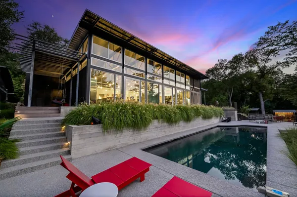 a backyard of a house with yard and outdoor seating