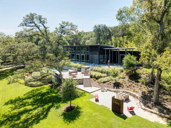 a view of backyard with plants and outdoor seating