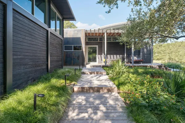 a front view of a house with garden