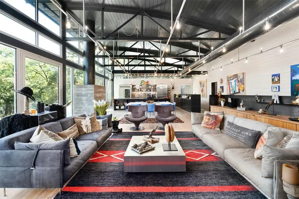 a living room with furniture fireplace and a table