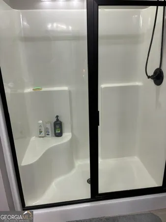 a white toilet sitting next to a white wall