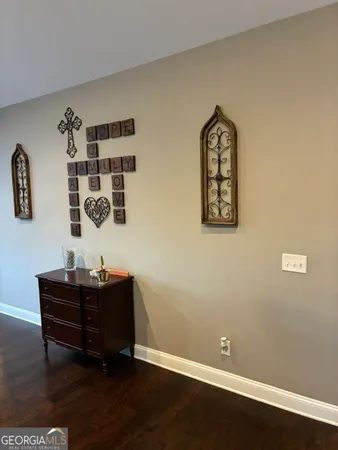 a living room with furniture and a view of kitchen