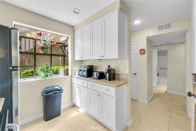 a kitchen with a refrigerator and a window