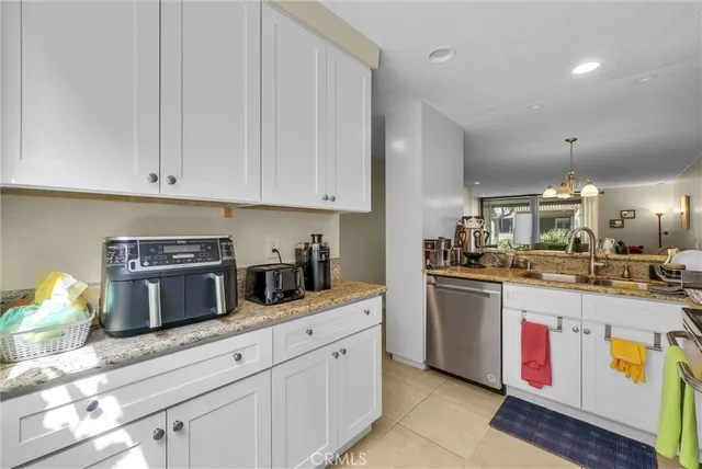a kitchen with stainless steel appliances granite countertop a sink and cabinets