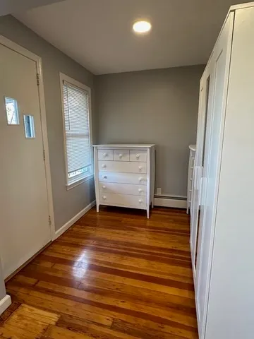 a view of room with window and wooden floor