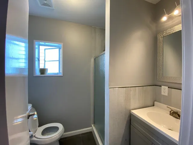 a bathroom with a sink a toilet and vanity