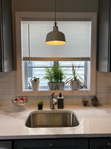 a kitchen sink with a sink and window