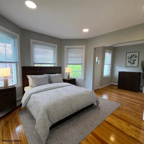 a bedroom with a bed and window