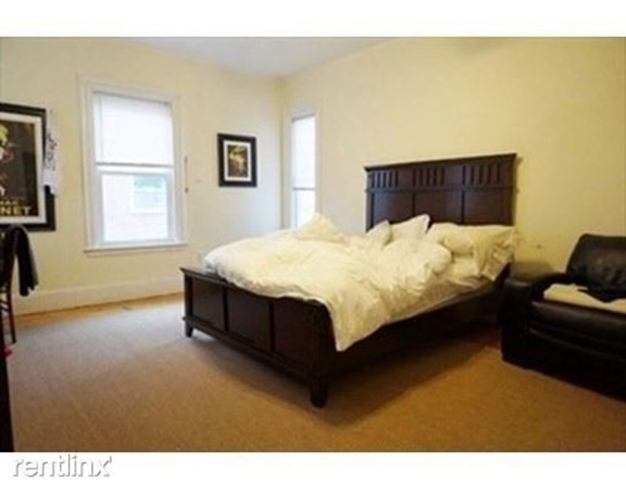 38 Gardner Street Boston, MA 02134 - Photo 2 of 11 a bed sitting in a bedroom next to a window