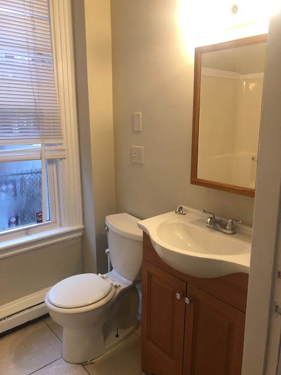 38 Gardner Street Boston, MA 02134 - Photo 3 of 11 a bathroom with a sink a toilet and mirror