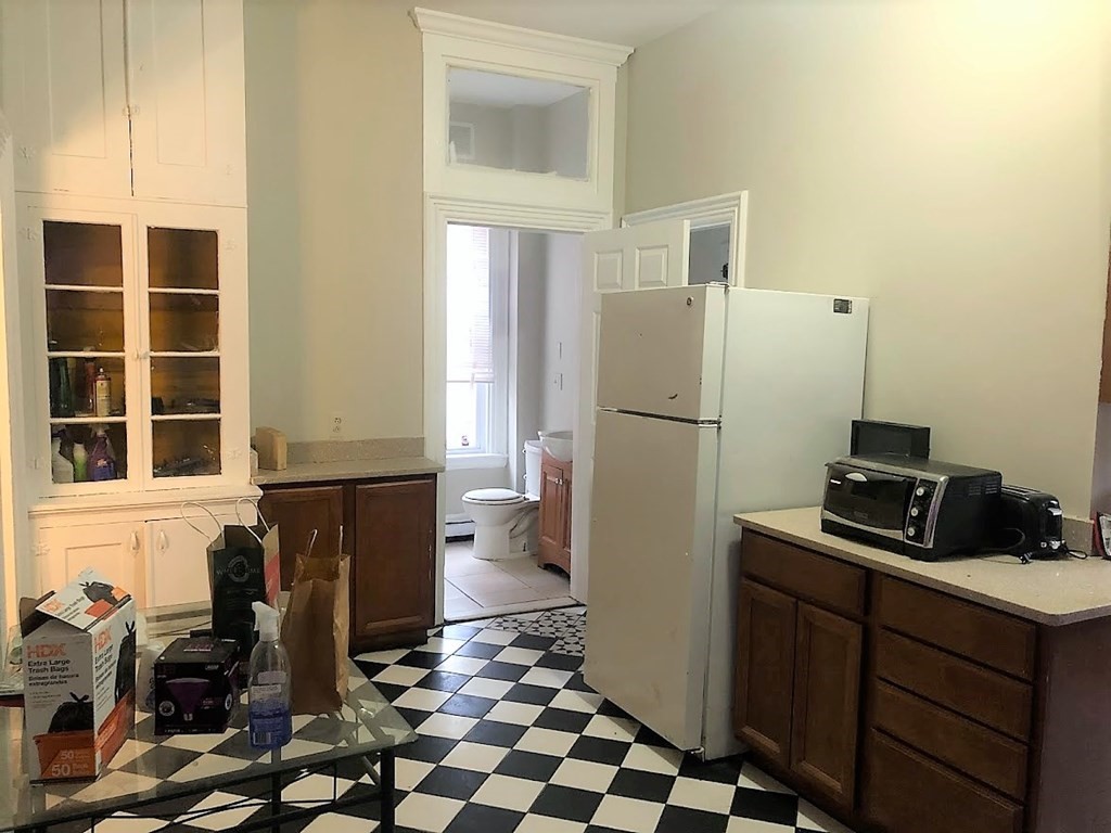 38 Gardner Street Boston, MA 02134 - Photo 4 of 11 a kitchen with a refrigerator a stove a sink and a window