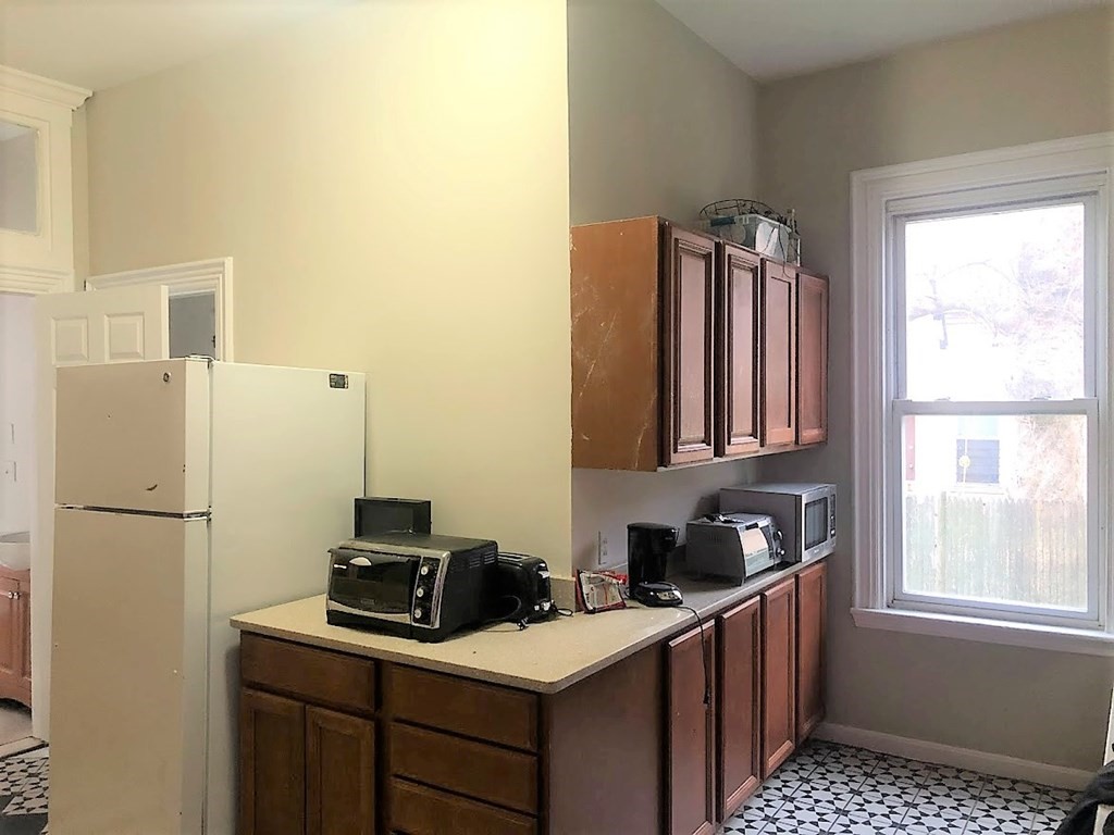 38 Gardner Street Boston, MA 02134 - Photo 5 of 11 a kitchen with a sink stove and refrigerator
