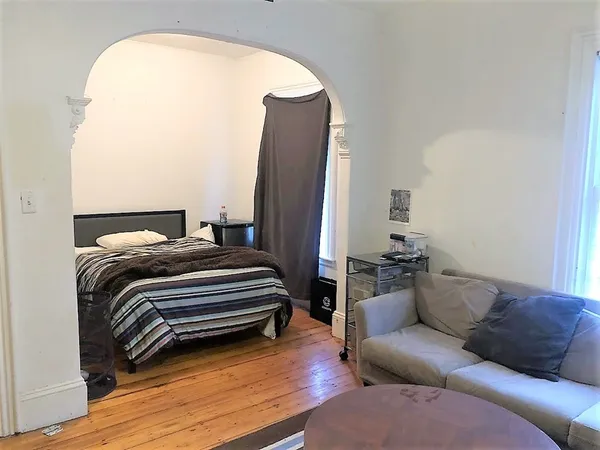 a view of a living room with wooden floor