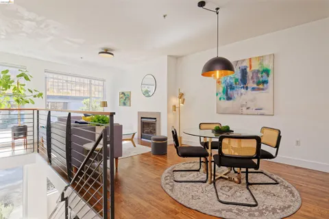 a dining room with furniture a chandelier and wooden floor