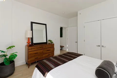 a bedroom with a bed and a potted plant