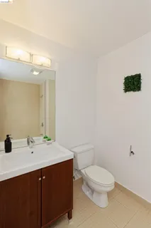 a bathroom with a sink a toilet and mirror