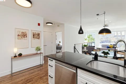 a kitchen with a sink and living room view