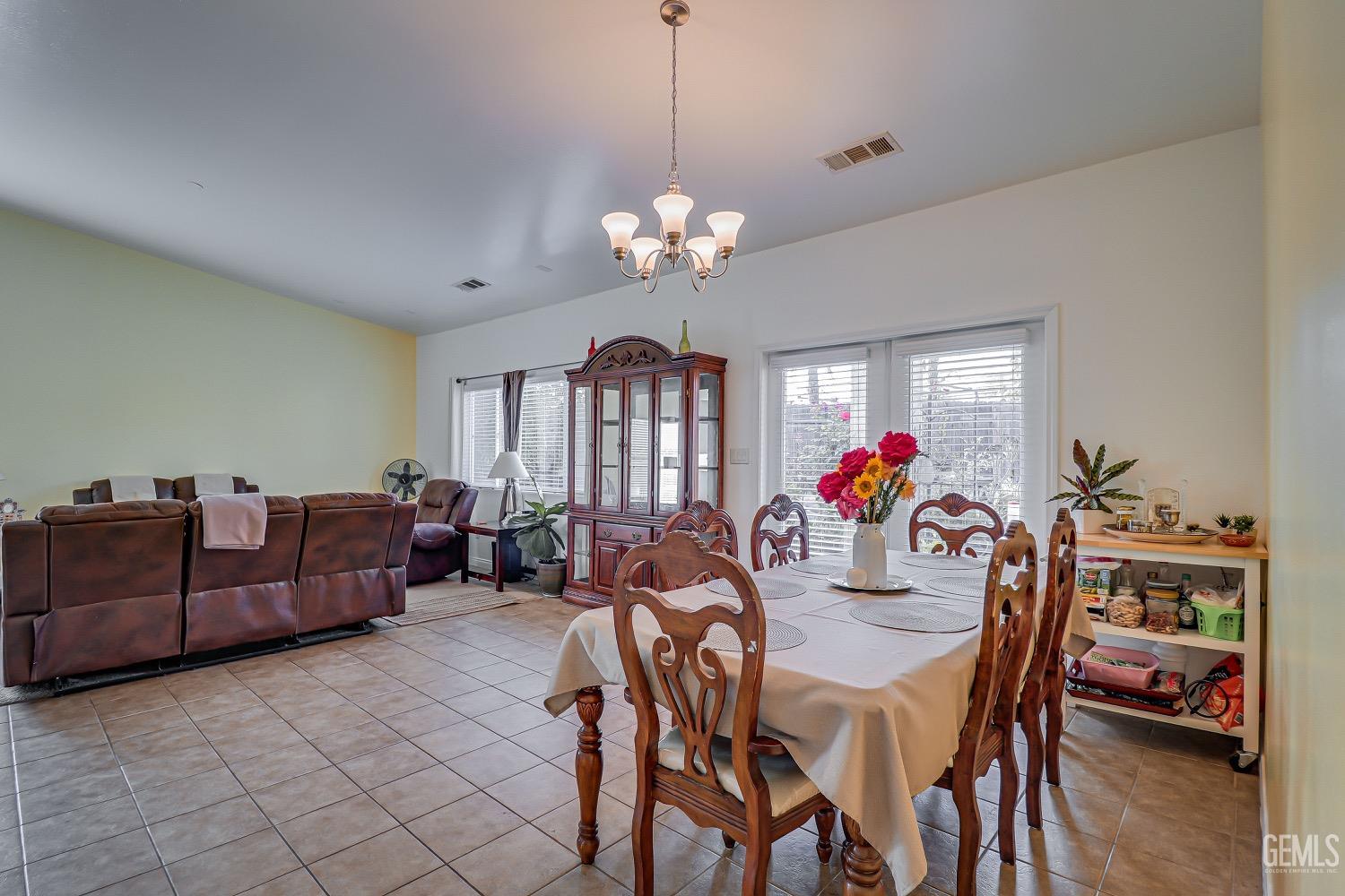 Undisclosed Address Bakersfield, CA 93311 - Photo 13 of 31 a view of a dining room with furniture wooden floor and chandelier