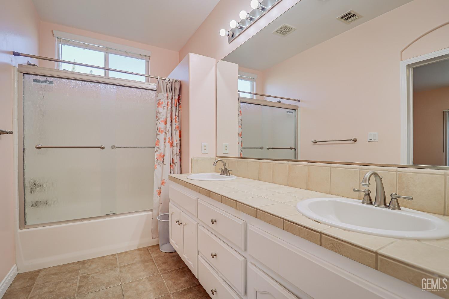 Undisclosed Address Bakersfield, CA 93311 - Photo 23 of 31 a bathroom with a double vanity sink mirror and shower