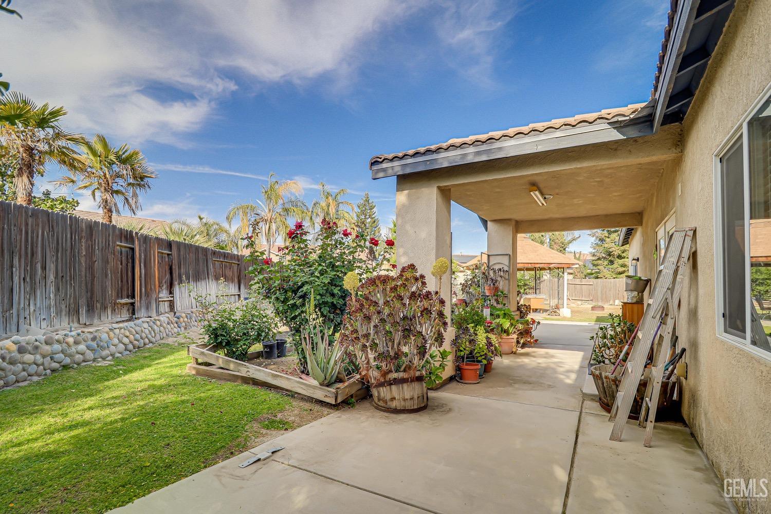 Undisclosed Address Bakersfield, CA 93311 - Photo 27 of 31 a view of a patio with table and chairs and potted plants