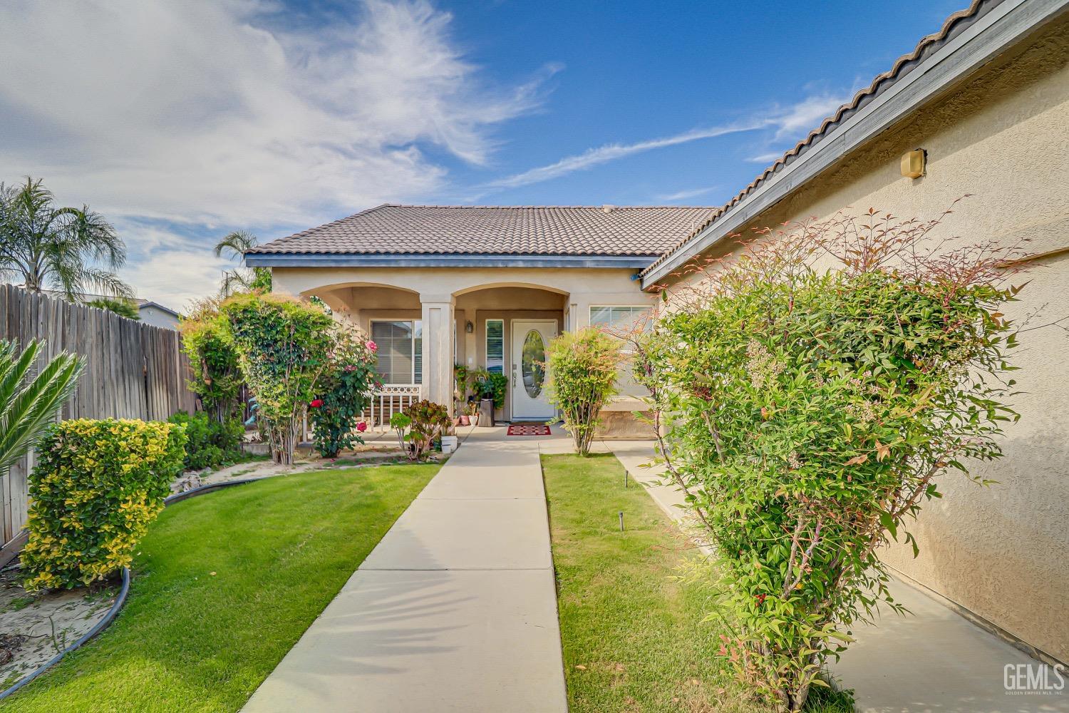 Undisclosed Address Bakersfield, CA 93311 - Photo 3 of 31 a front view of a house with a yard