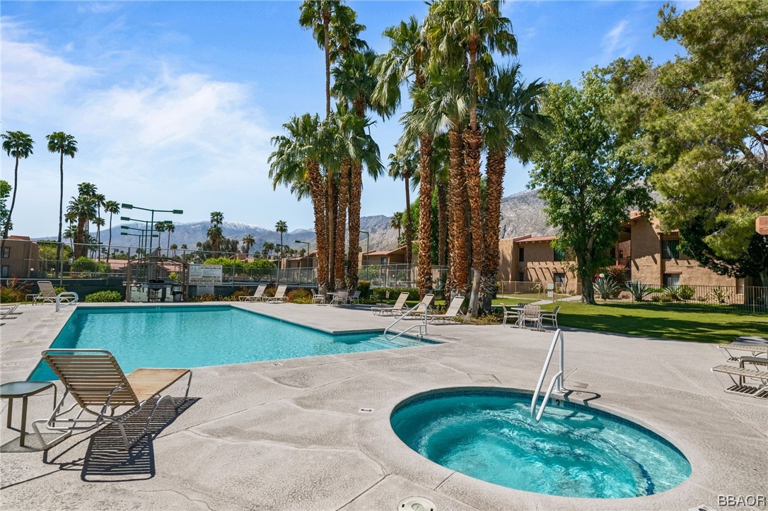 1050 Ramon Road, Unit 8 Palm Springs, CA 92264 - Photo 14 of 31 a swimming pool with outdoor seating and yard