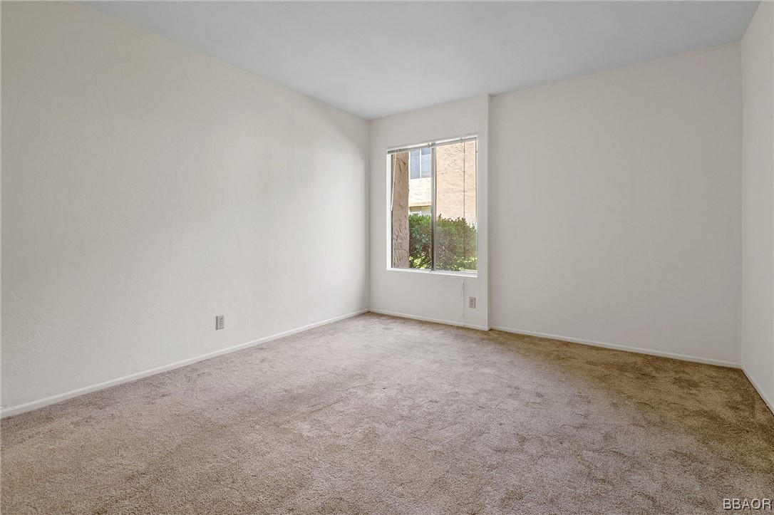 1050 Ramon Road, Unit 8 Palm Springs, CA 92264 - Photo 18 of 31 an empty room with windows