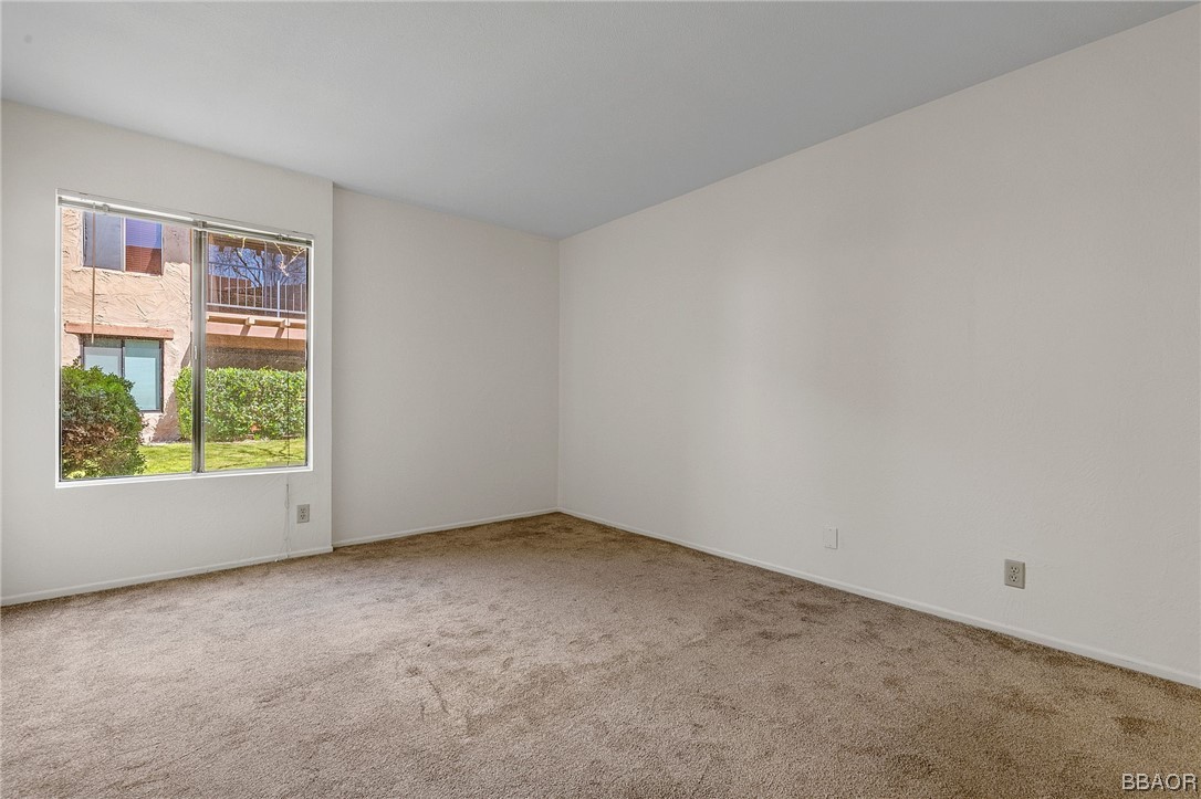 1050 Ramon Road, Unit 8 Palm Springs, CA 92264 - Photo 19 of 31 an empty room with windows