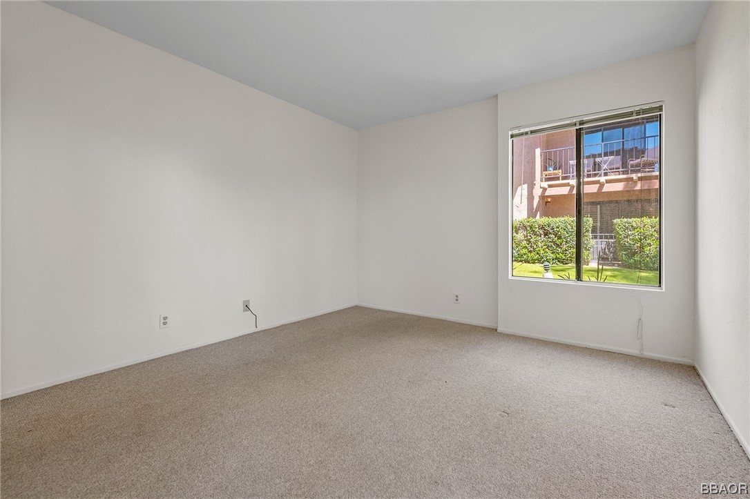 1050 Ramon Road, Unit 8 Palm Springs, CA 92264 - Photo 23 of 31 an empty room with a window