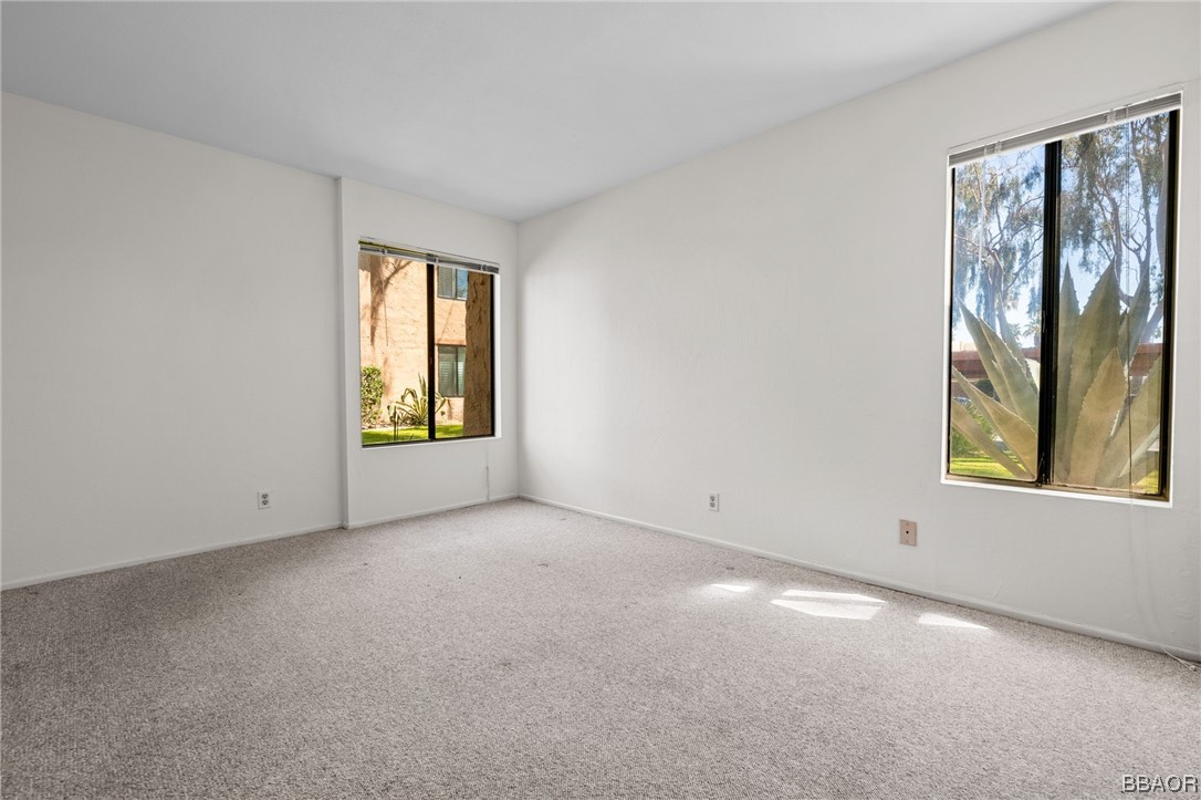 1050 Ramon Road, Unit 8 Palm Springs, CA 92264 - Photo 24 of 31 an empty room with windows