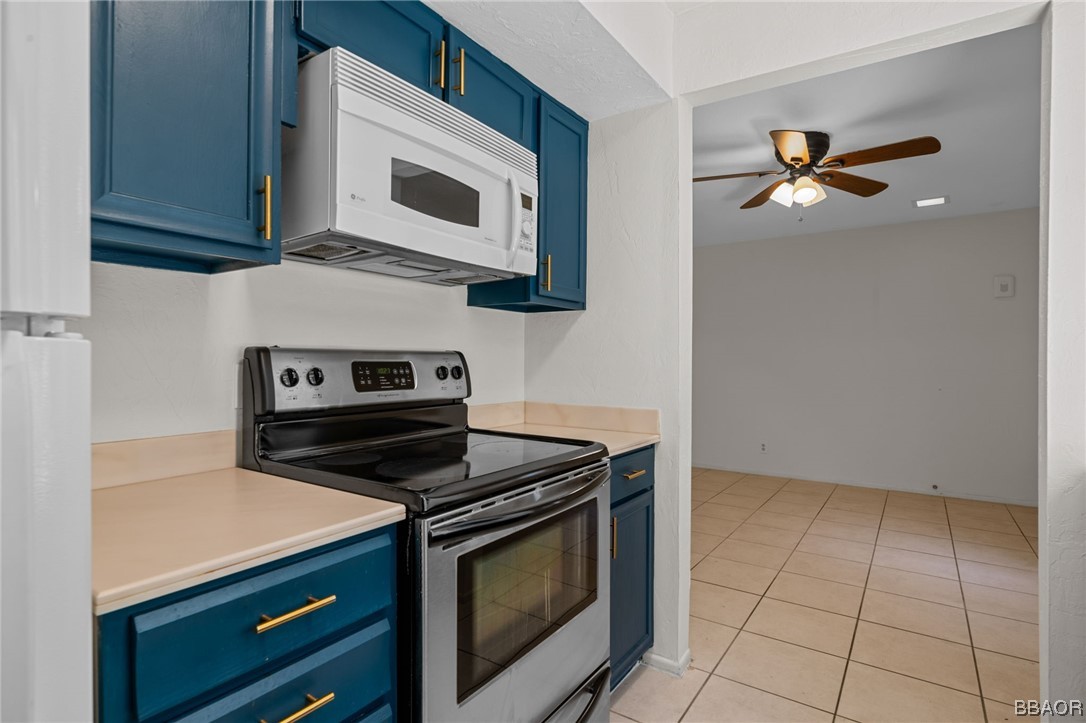 1050 Ramon Road, Unit 8 Palm Springs, CA 92264 - Photo 10 of 31 a kitchen with granite countertop white cabinets stainless steel appliances and a sink