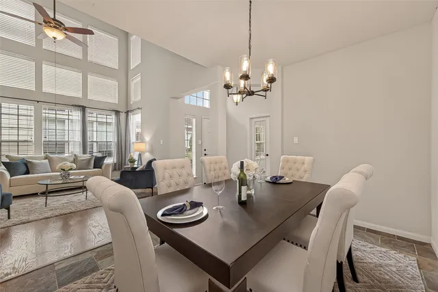 a view of a dining room with furniture a chandelier and wooden floor