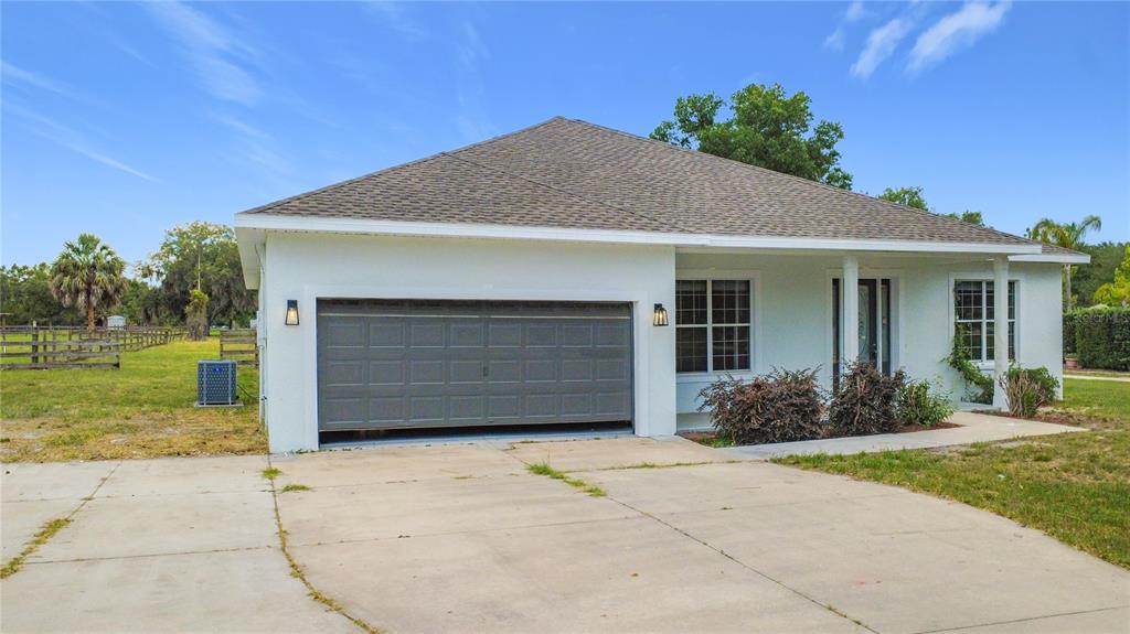 28549 Shirley Shores Road Tavares, FL 32778 - Photo 7 of 65 a front view of a house with garden