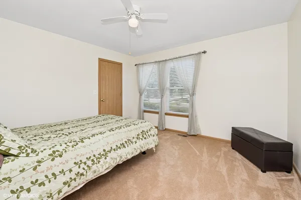 a bedroom with a bed and a window