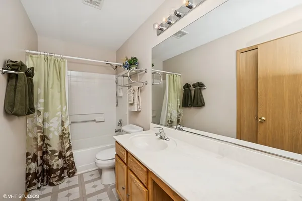 a bathroom with a sink and mirror with toilet