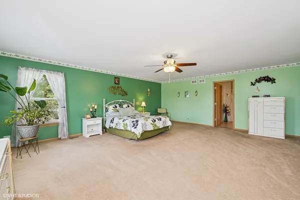 a bedroom with furniture and a chandelier