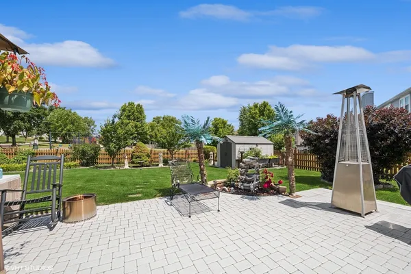a view of a patio with a table and chairs