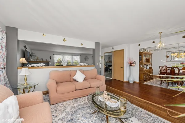 a living room with furniture and wooden floor