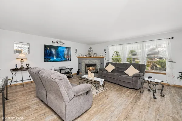 a living room with furniture and a fireplace