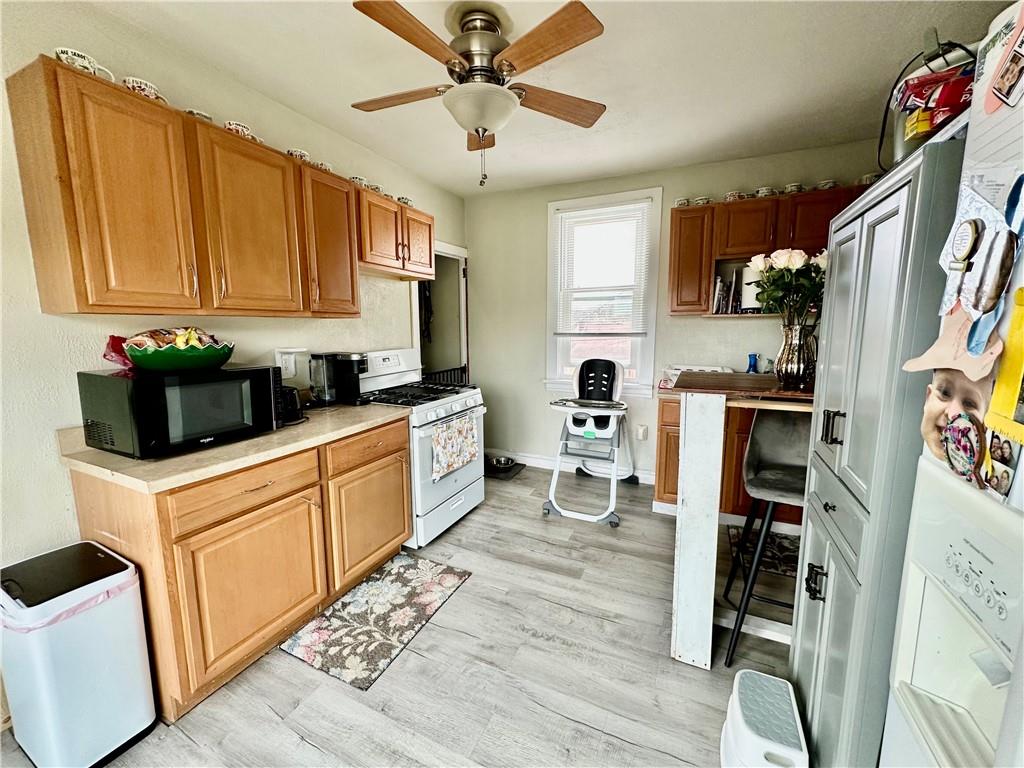 625 Delaware Street Monessen, PA 15062 - Photo 12 of 15 a kitchen with stainless steel appliances a stove a sink cabinets and a refrigerator