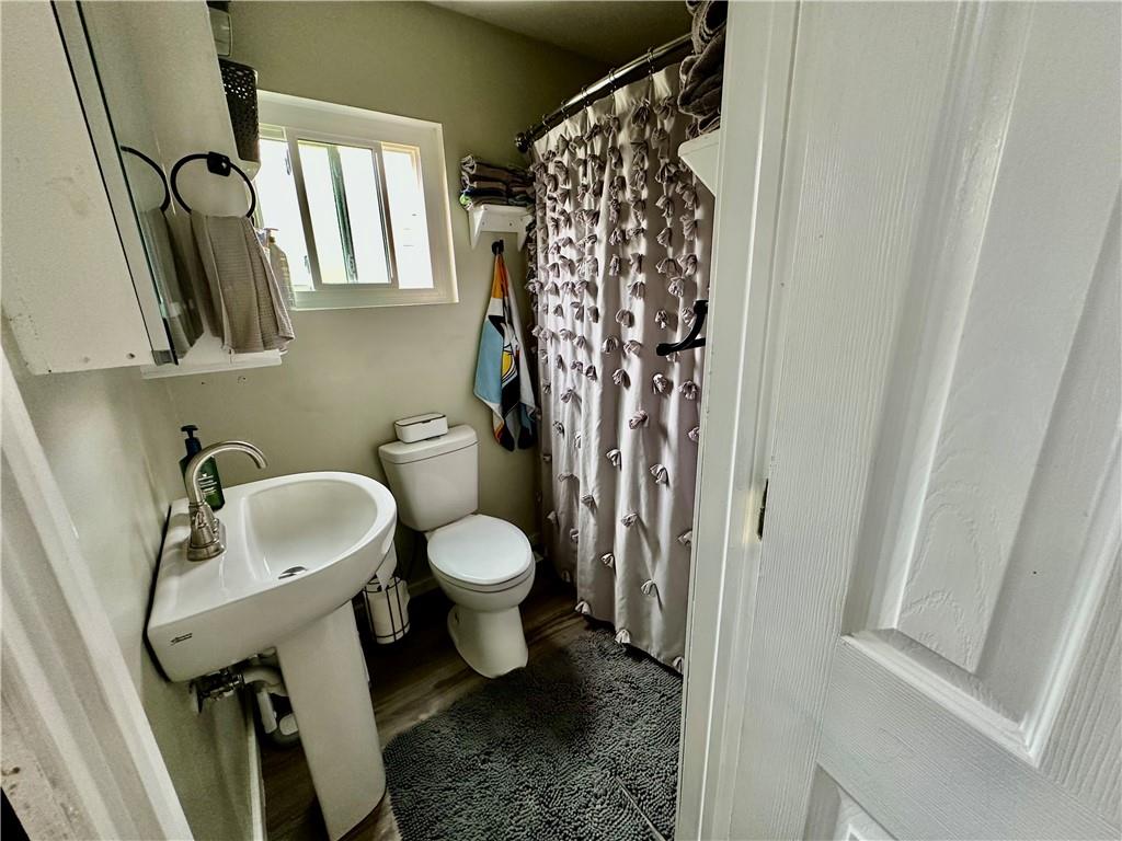 625 Delaware Street Monessen, PA 15062 - Photo 13 of 15 a bathroom with a toilet sink and mirror