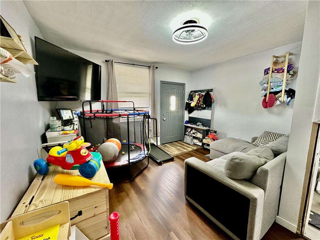 625 Delaware Street Monessen, PA 15062 - Photo 6 of 15 a living room with furniture and a flat screen tv