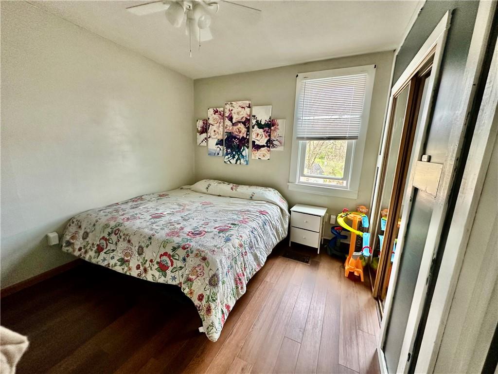 625 Delaware Street Monessen, PA 15062 - Photo 7 of 15 a bedroom with a large bed and a chandelier