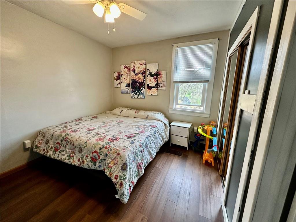 625 Delaware Street Monessen, PA 15062 - Photo 9 of 15 a bedroom with a bed and a chandelier