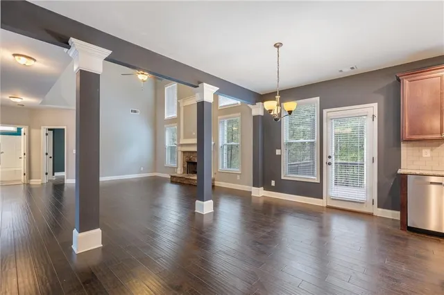 a bathroom with a granite countertop bathtub shower sink vanity mirror and toilet