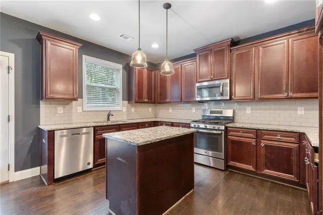a view of staircase with lots of frames on wall and a window