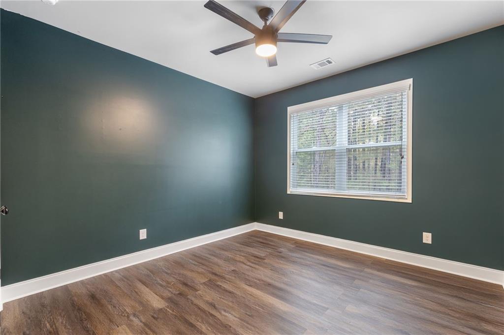 1023 Ruddy Duck Drive Jefferson, GA 30549 - Photo 27 of 69 a view of an empty room with window and wooden floor