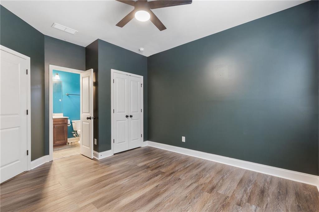 1023 Ruddy Duck Drive Jefferson, GA 30549 - Photo 28 of 69 an empty room with wooden floor and chandelier fan