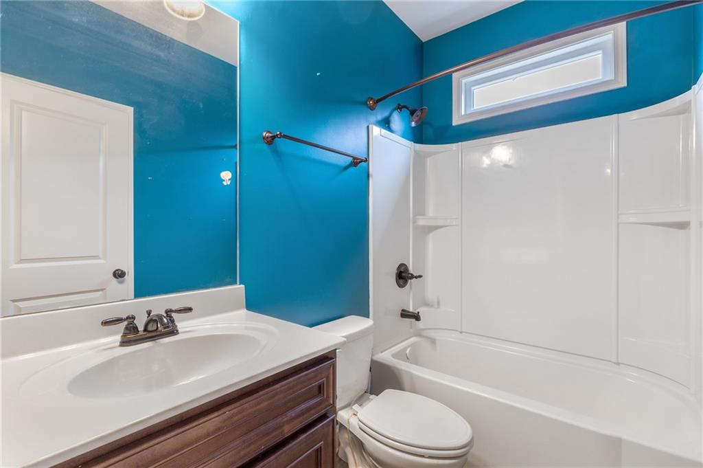 1023 Ruddy Duck Drive Jefferson, GA 30549 - Photo 29 of 69 a bathroom with a granite countertop bathtub shower sink vanity mirror and toilet