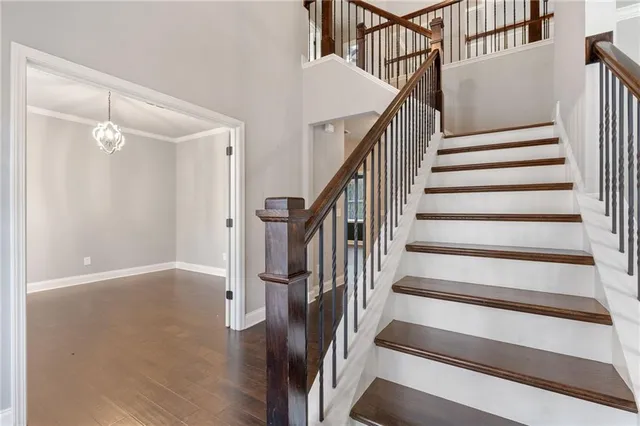 a view of a hallway with wooden floor and entryway